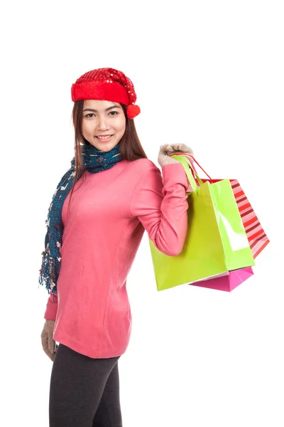 Asian girl with red christmas hat with shopping bags — Stock Photo, Image