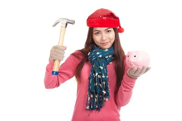 Asian girl with red christmas hat ,hammer and piggy bank — Stock Photo, Image