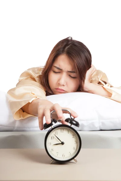 Sleepy Asian girl with alarm clock — Stock Photo, Image