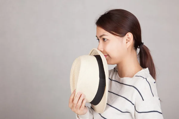 Beautiful Asian girl hold  a  hat close her mouth — Stock Photo, Image