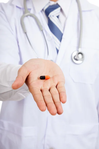 Asian male doctor show a capsule on palm hand — Stock Photo, Image