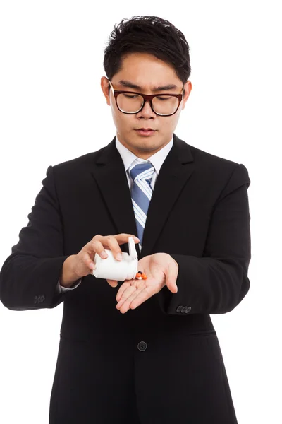 Asian businessman put medicine in his hand — Stock Photo, Image