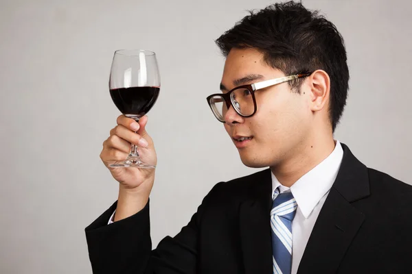 Asian businessman look at  red wine — Stock Photo, Image