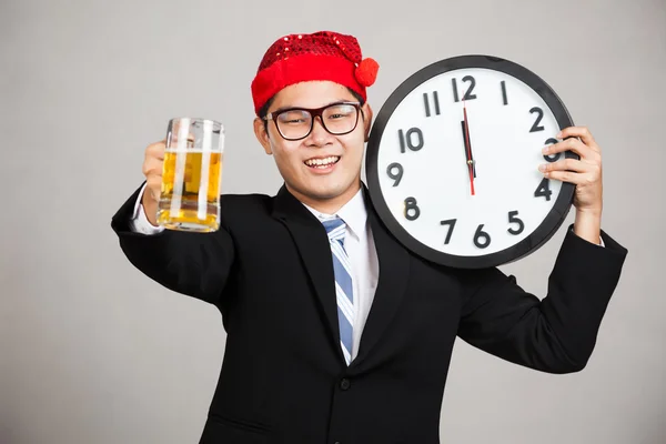 Happy Asian businessman with beer and clock at  midnight — Stock Photo, Image