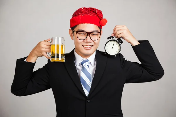 Happy Asian businessman with beer and clock at  midnight — Stock Photo, Image