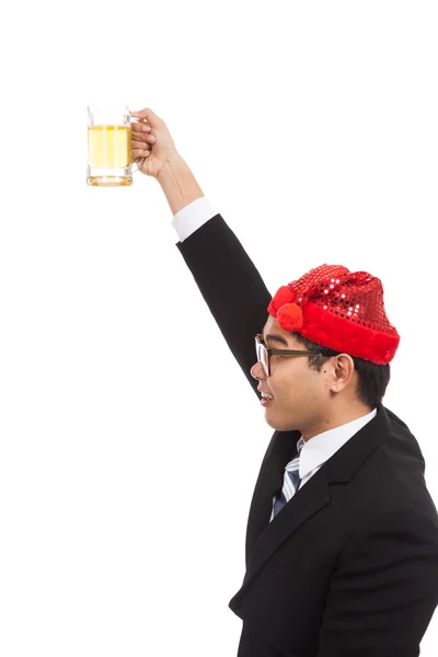 Asian businessman with red  christmas hat cheers with mug of bee — Stock Photo, Image