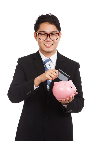 Asian businessman put credit card to piggy bank — Stock Photo, Image