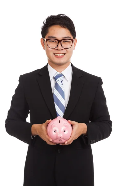 Asiatische Geschäftsmann halten ein rosa Sparschwein — Stockfoto