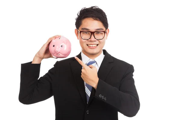 Asian businessman point to a pink piggy bank — Stock Photo, Image