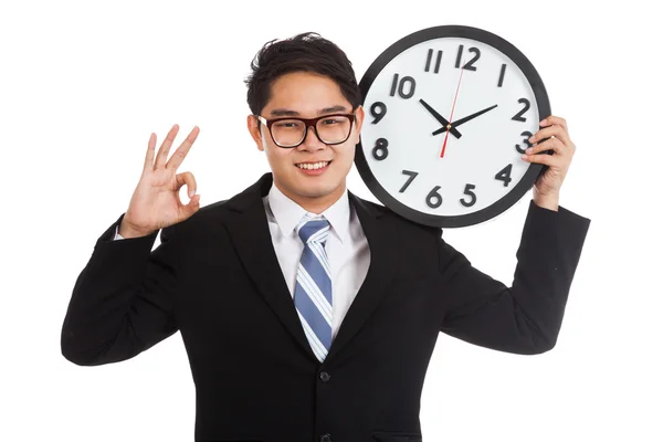 Asian businessman show OK with a clock — Stock Photo, Image