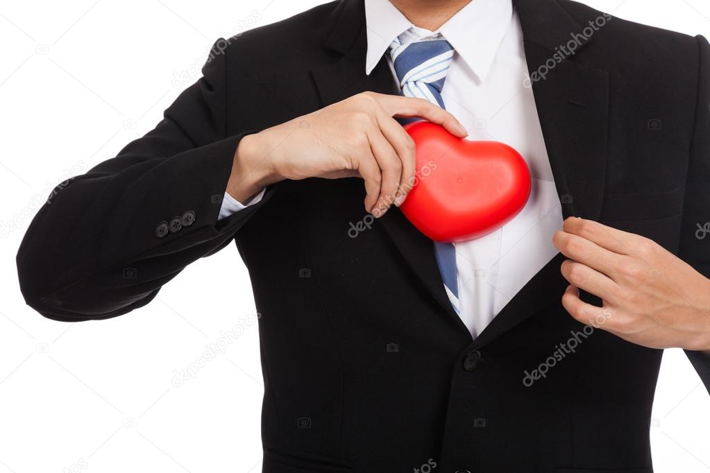 Asian businessman pull red heart  from his suit