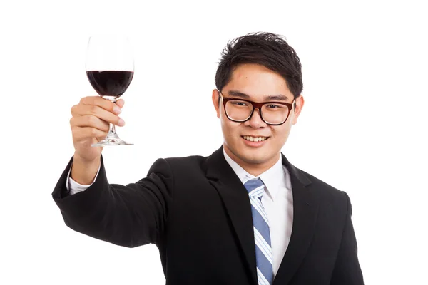 Asian businessman cheers with glass of red wine — Stock Photo, Image