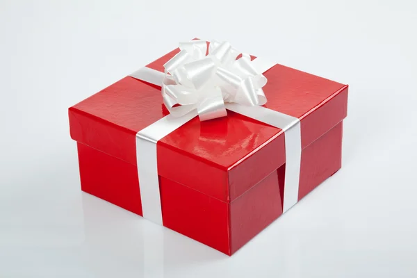 Red gift box with white bow for christmas — Stock Photo, Image