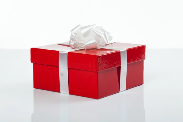 Red gift box with white bow for christmas — Stock Photo, Image