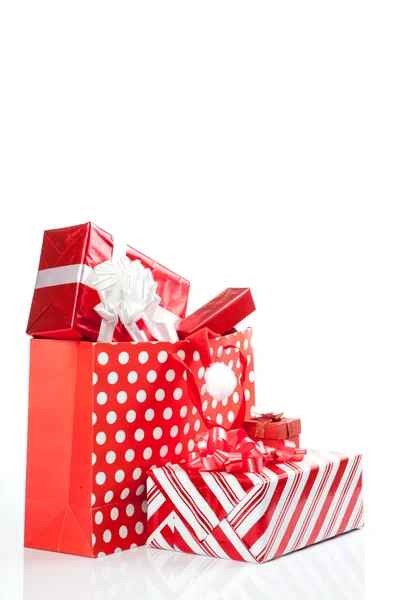 Red gift boxes and and christmas hat in shopping bags — Stock Photo, Image