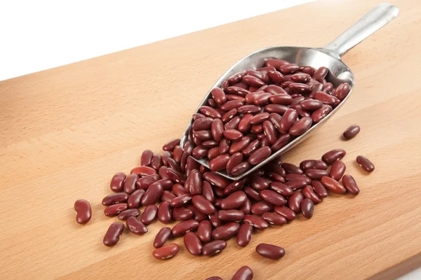 Red kidney beans with scoop on wood table — Stock Photo, Image