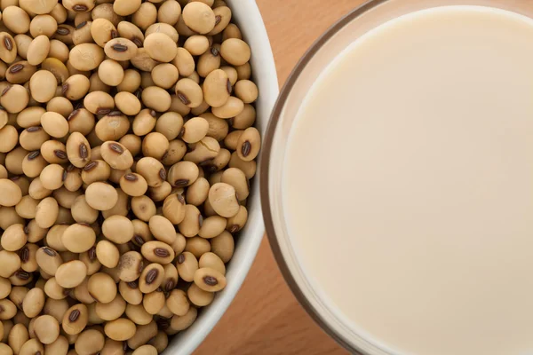 Soy milk in glass with soybeans — Stock Photo, Image
