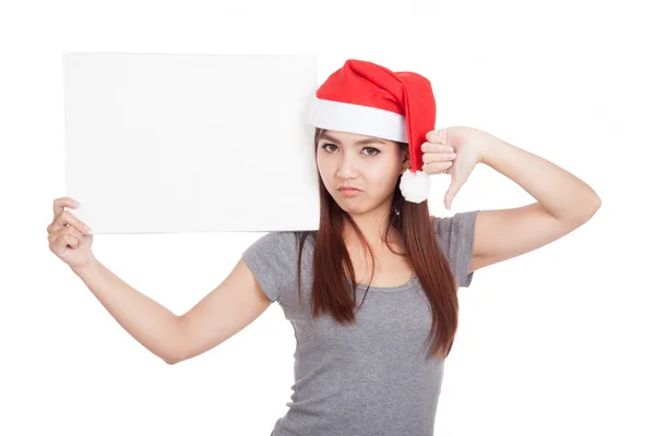 Asian girl with red santa hat thumbs down with a blank sign — Stock Photo, Image