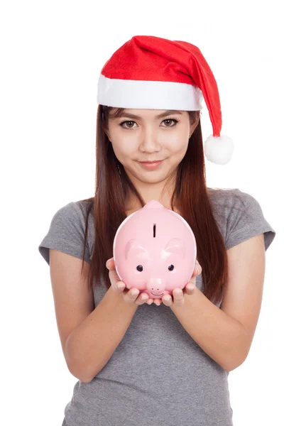 Asian girl with red santa hat hold a pink piggy bank — Stock Photo, Image