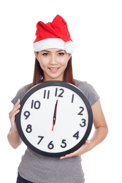 Asian girl with red santa hat and clock — Stock Photo, Image