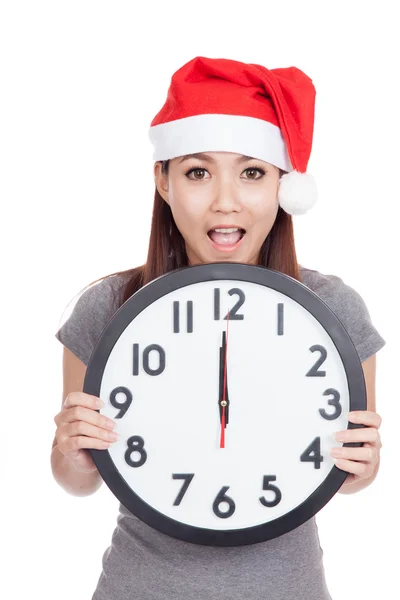 Asian girl wear red christmas hat excited with clock at midnight — Stock Photo, Image
