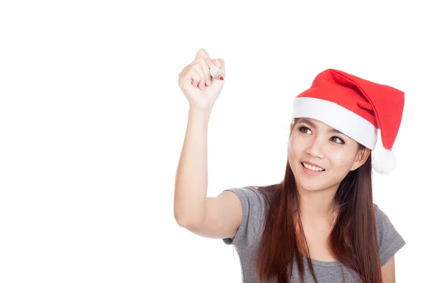 Asian girl with red santa hat write in the air and smile — Stock Photo, Image