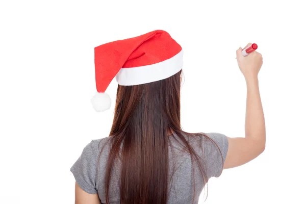 Costas de menina asiática com chapéu vermelho santa escrever no ar — Fotografia de Stock