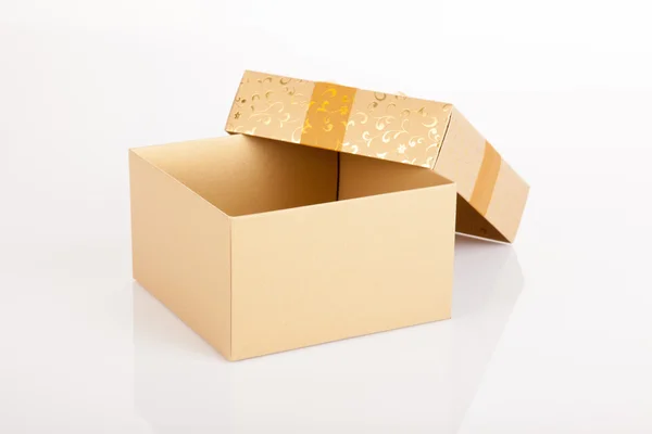 Golden christmas gift box with lid off — Stock Photo, Image