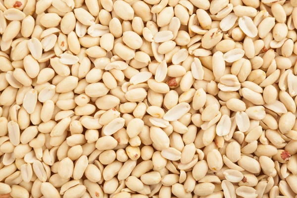 Amendoins descascados como fundo, textura — Fotografia de Stock