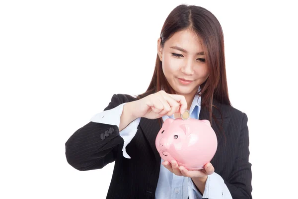 Young Asian businesswoman with a coin and piggy bank — Stock Photo, Image