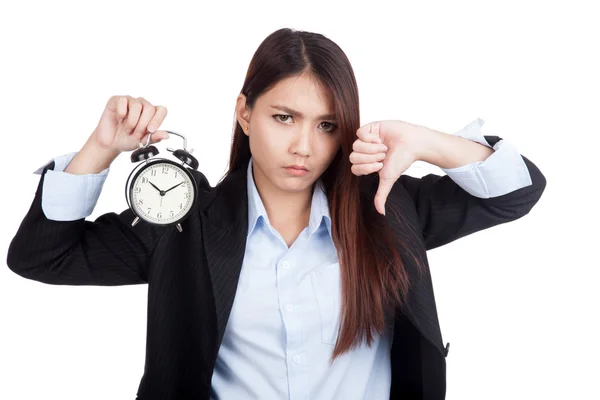 Young Asian businesswoman thumbs down with alarm clock — Stock Photo, Image