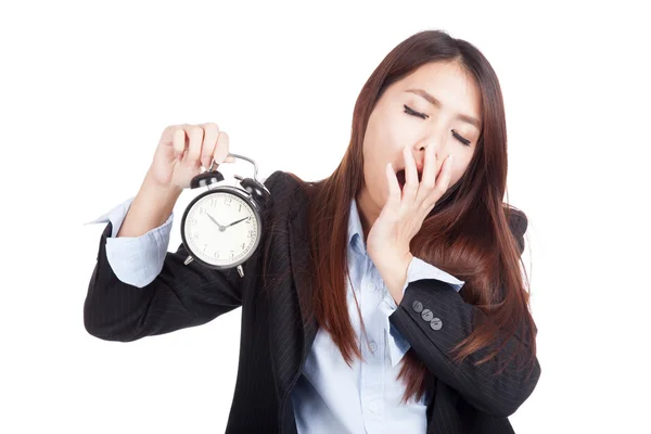 Young Asian businesswoman yawn with alarm clock — Stock Photo, Image