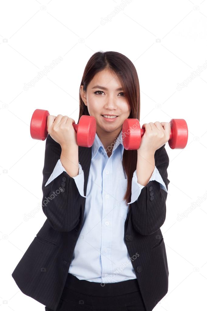 Young Asian businesswoman with red dumbbells