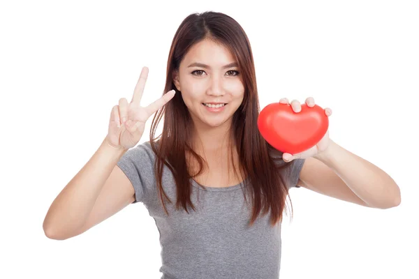 Young Asian woman show victory sign with red heart — Stock Photo, Image