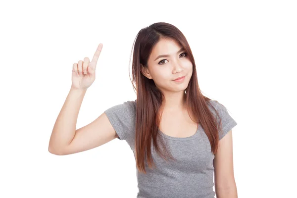 Joven asiática sonrisa y apuntar hacia arriba — Foto de Stock