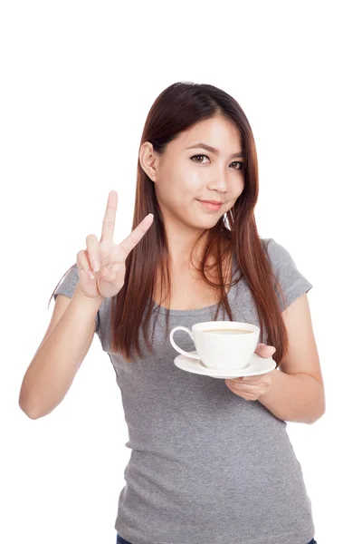 Young Asian woman show V sign with cup of coffee — Stock Photo, Image