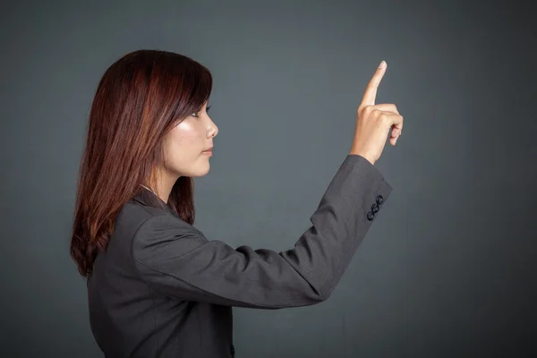 Side view of Asian business woman touching the screen — Stock Photo, Image