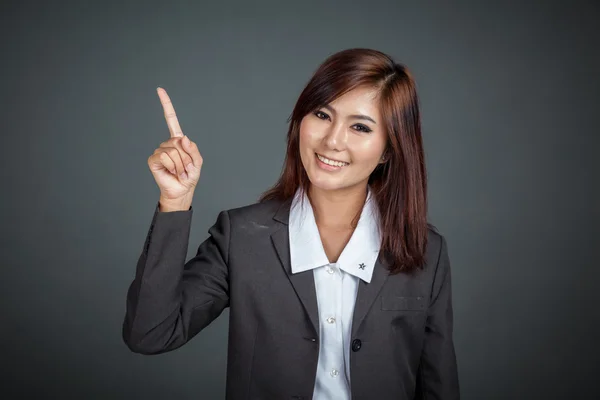 Happy Asian business woman point to her left — Stock Photo, Image