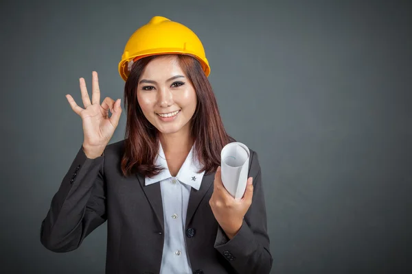 Asian engineer girl hold a blueprint show Ok sign — Stock Photo, Image