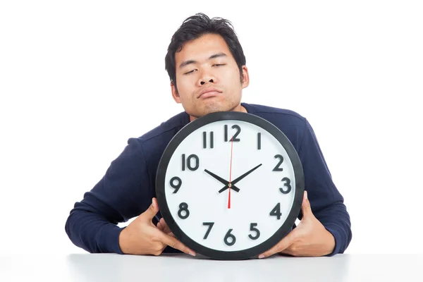 Asian man is sleepy with a clock — Stock Photo, Image