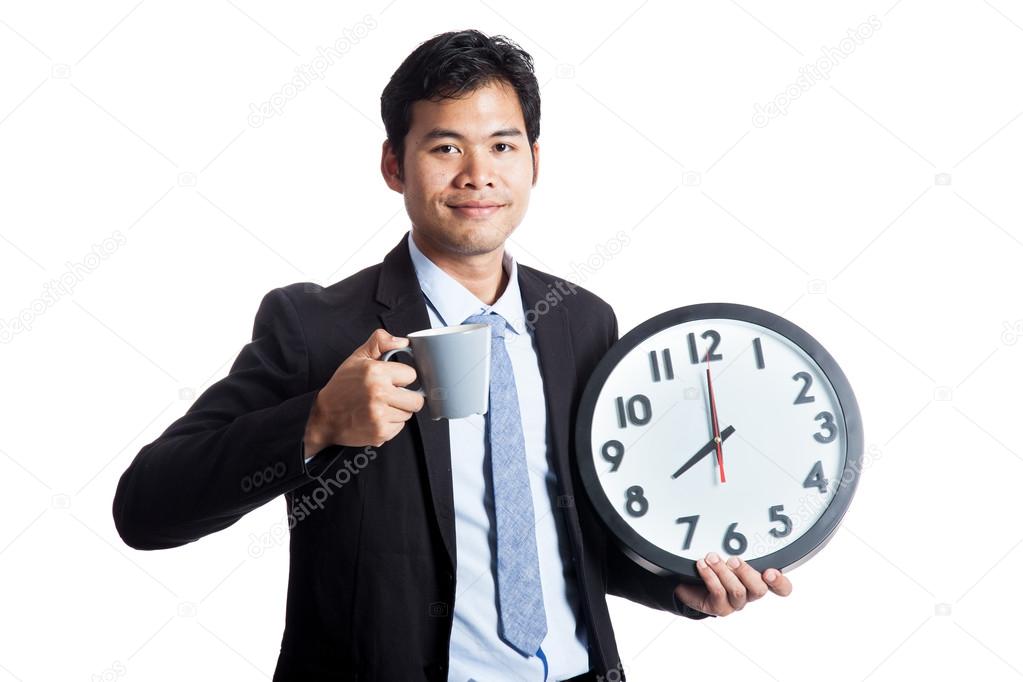 Asian office man smile with a clock and a cup of coffee