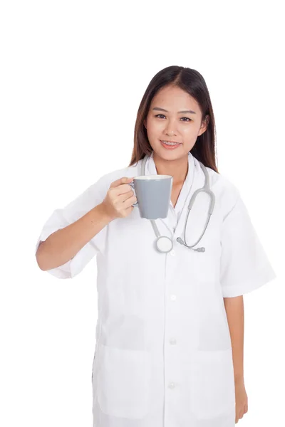 Молодая азиатка-врач держит кружку и улыбается — стоковое фото