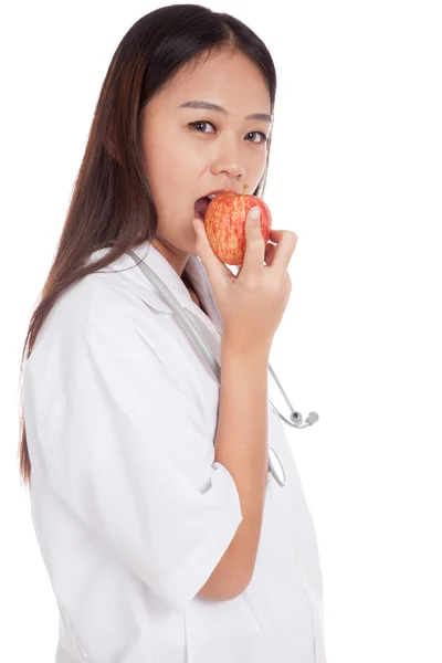 Giovane asiatico femmina medico mordere mela — Foto Stock