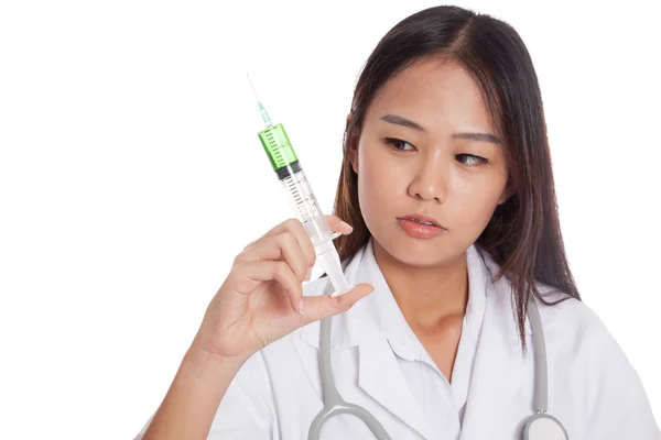 Young Asian female doctor look at syringe — Stock Photo, Image