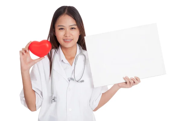 Young Asian female doctor with red heart and blank sign — Stock Photo, Image