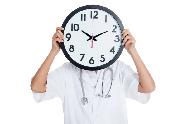 Doctor hold a clock over her face — Stock Photo, Image