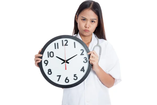 Frustré jeune asiatique femme médecin avec une horloge — Photo