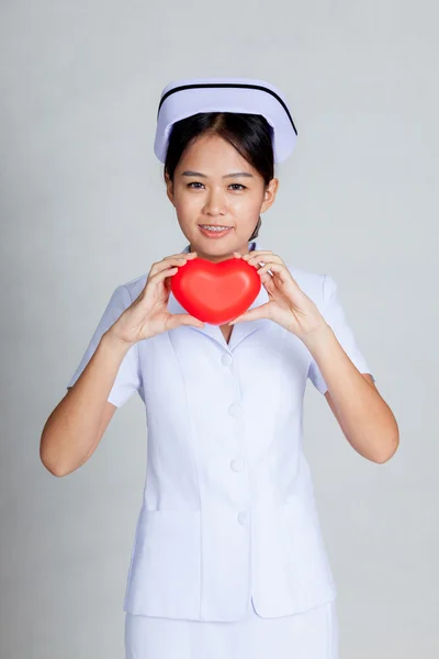 Young Asian nurse show red heart with both hand — Stock Photo, Image