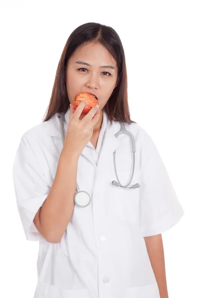 Giovane asiatico femmina medico mordere mela — Foto Stock