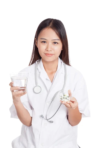 Young Asian female doctor with water and medicine — Stock Photo, Image